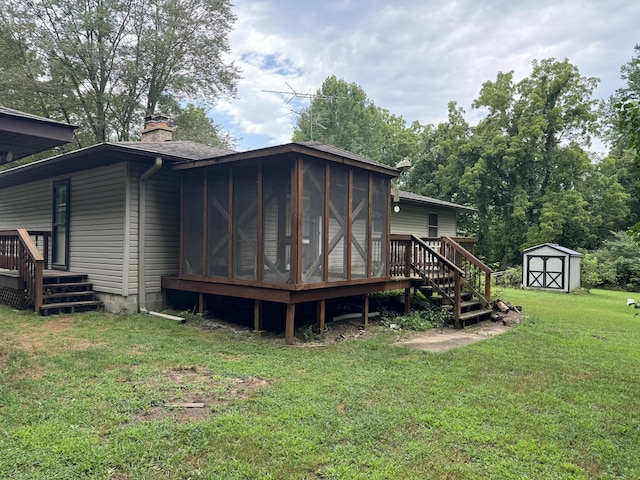 rear view of property featuring a sunroom, a shed, a wooden deck, and a lawn