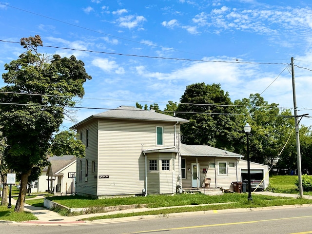 view of front of house with a garage and an outdoor structure