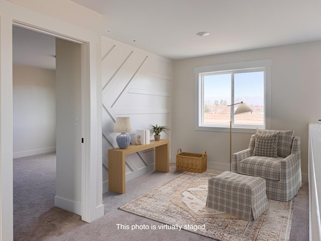 living area with carpet floors and baseboards