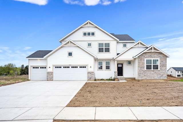 craftsman-style home with stone siding, concrete driveway, and a garage