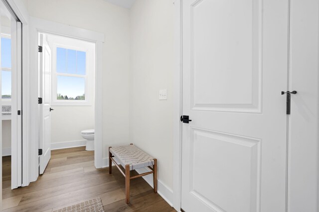 mudroom featuring light wood-style flooring and baseboards