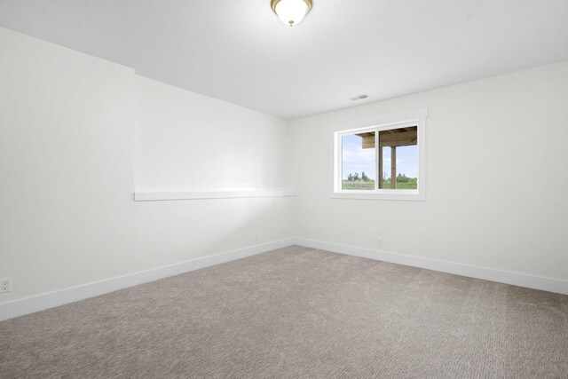 carpeted empty room with baseboards