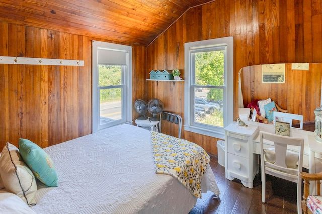 bedroom featuring dark hardwood / wood-style flooring, vaulted ceiling, and wood walls