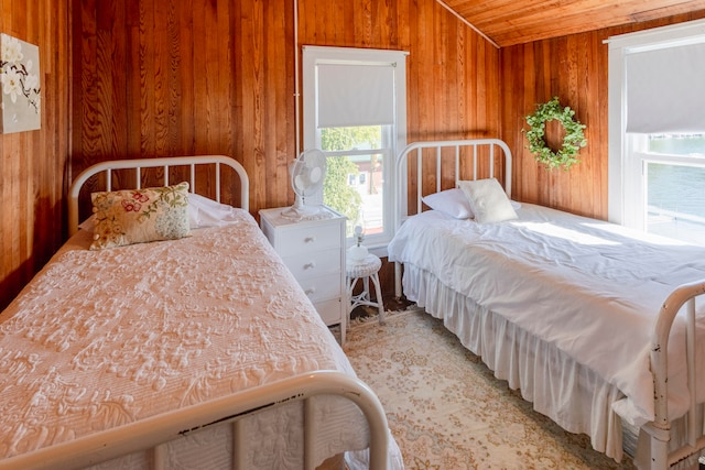 bedroom with wood walls and carpet floors