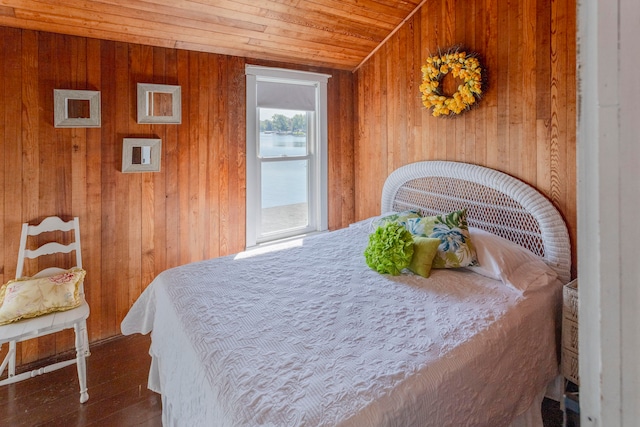 bedroom with wooden walls and wood ceiling