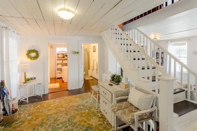 stairs with wood-type flooring and wood ceiling