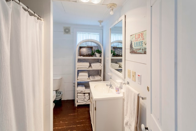 bathroom featuring hardwood / wood-style floors, vanity, and toilet