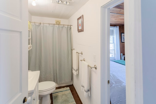 bathroom with toilet and curtained shower