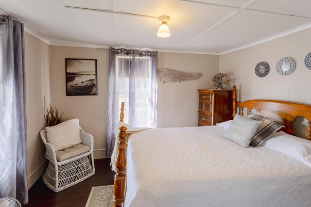 976 Doster Rd, Plainwell, MI 49080 - bedroom with crown molding, wood finished floors, and baseboards