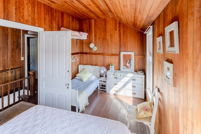 bedroom with dark hardwood / wood-style floors, wood walls, wood ceiling, and lofted ceiling