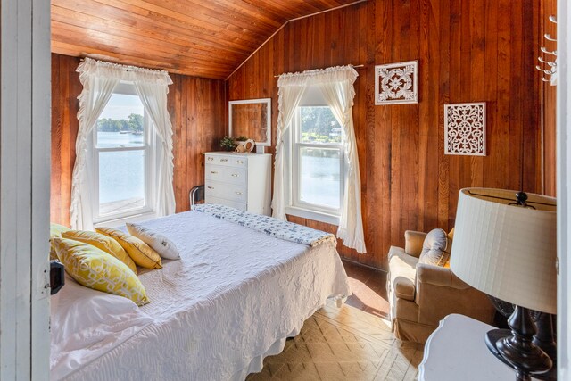 bedroom featuring lofted ceiling, wooden walls, and wooden ceiling