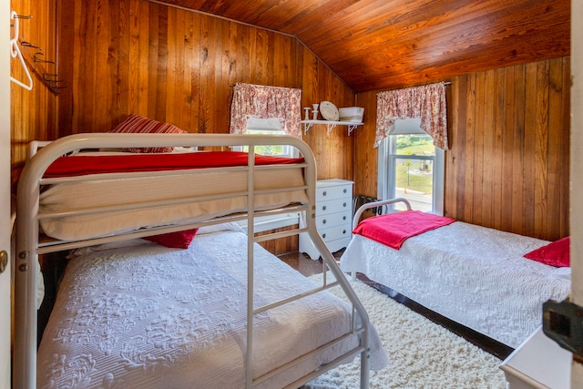 bedroom with wood walls, lofted ceiling, and wooden ceiling