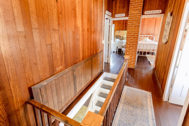 corridor featuring wood walls and dark hardwood / wood-style flooring