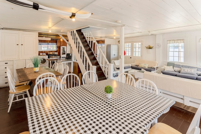 dining area featuring washer / clothes dryer and dark wood-type flooring