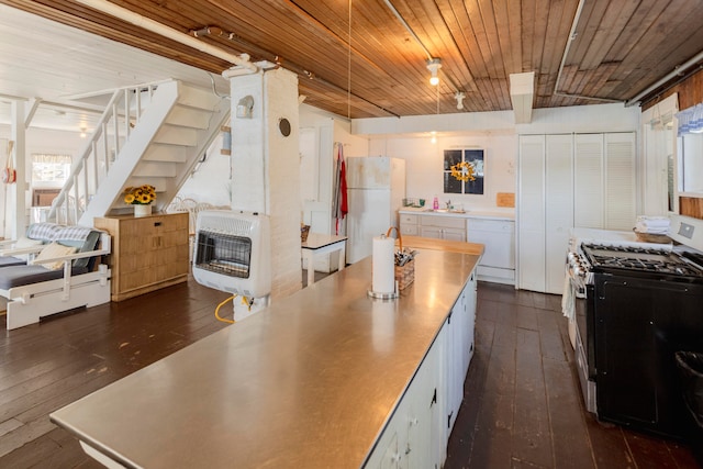 kitchen featuring white appliances, heating unit, white cabinetry, and wood ceiling