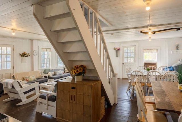 interior space with a wealth of natural light, dark wood-type flooring, and wooden ceiling