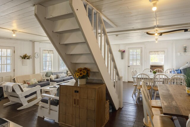976 Doster Rd, Plainwell, MI 49080 - living room featuring dark wood-style flooring, wooden ceiling, and stairs