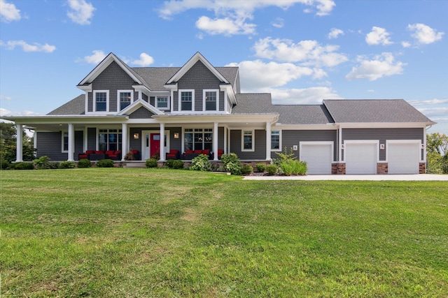 view of front of house featuring a porch, a front yard, driveway, and a garage