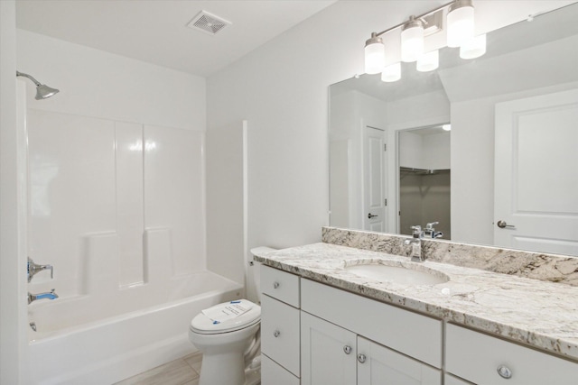 bathroom featuring washtub / shower combination, visible vents, vanity, and toilet