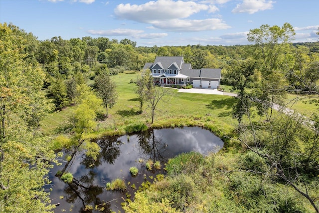 birds eye view of property featuring a water view and a view of trees