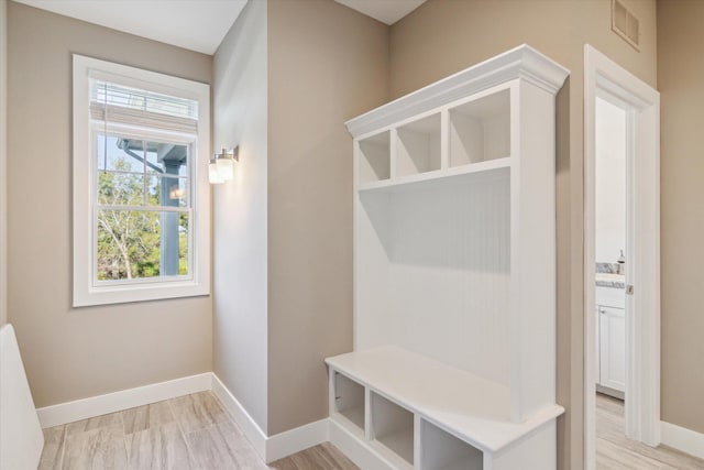 mudroom featuring light wood-style floors, visible vents, and baseboards