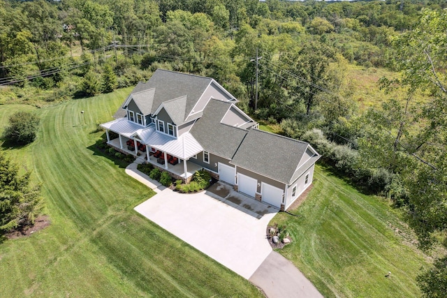 birds eye view of property featuring a wooded view