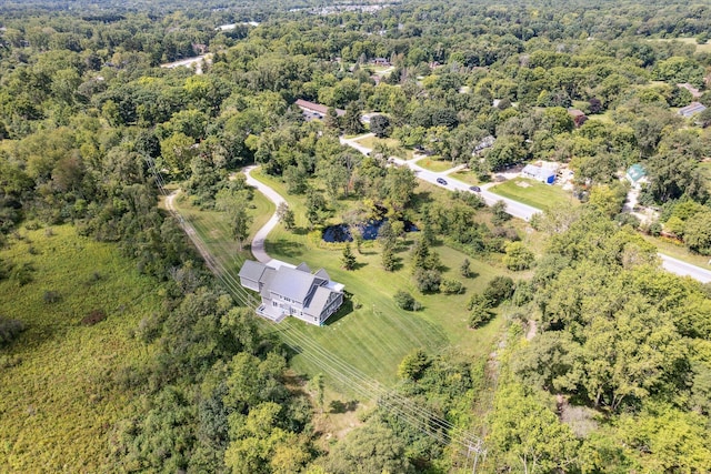 birds eye view of property featuring a wooded view