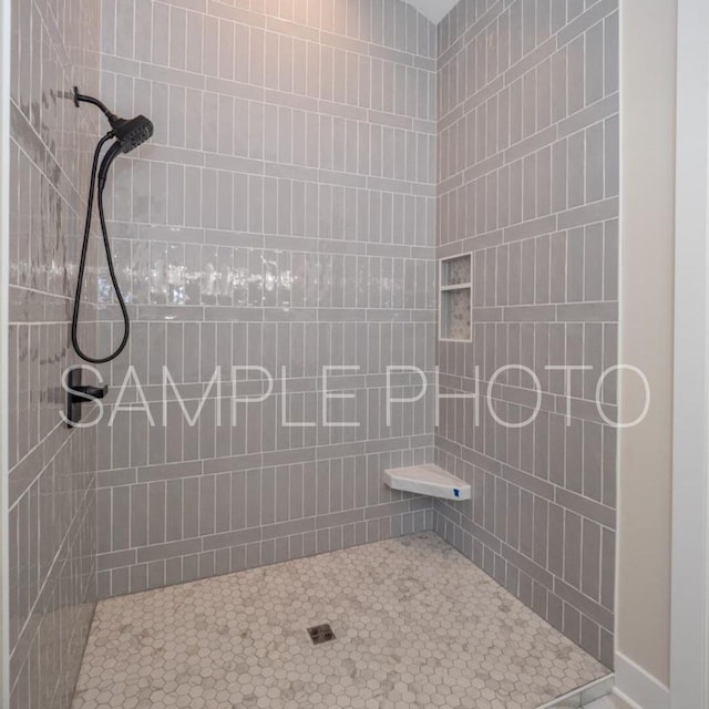 bathroom with tiled shower