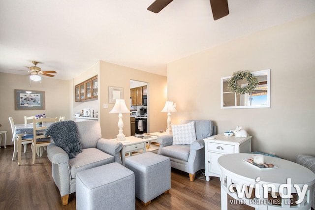 living room featuring ceiling fan and dark hardwood / wood-style flooring