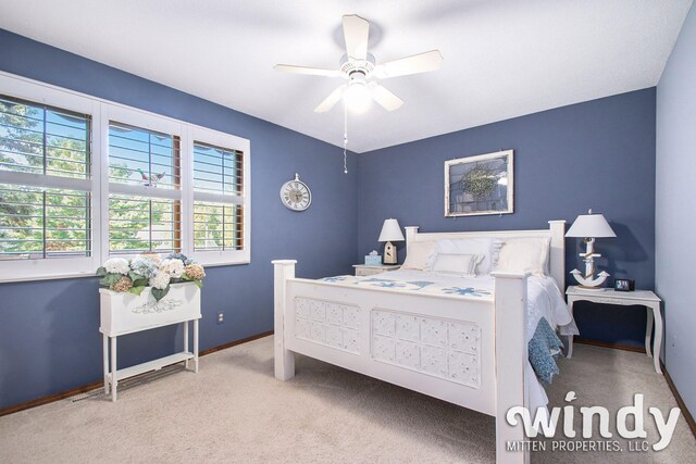 bedroom featuring ceiling fan and light colored carpet