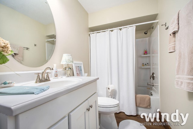 full bathroom featuring hardwood / wood-style floors, vanity, shower / bath combo, and toilet