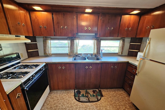 kitchen with white appliances, a healthy amount of sunlight, and sink