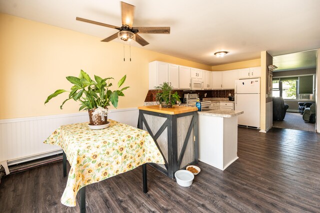 kitchen with white appliances, dark wood-type flooring, ceiling fan, white cabinetry, and kitchen peninsula