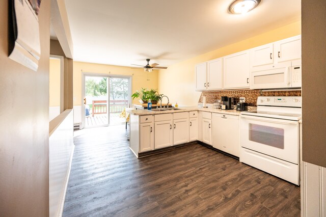 kitchen featuring kitchen peninsula, dark hardwood / wood-style flooring, white appliances, sink, and white cabinets