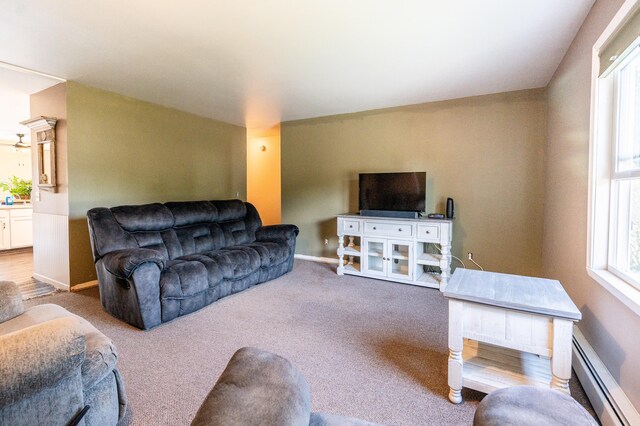 carpeted living room featuring baseboard heating