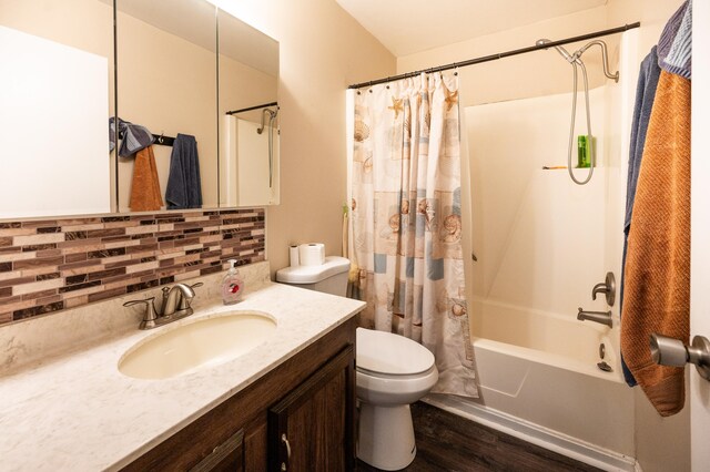 full bathroom featuring shower / bath combo, vanity, hardwood / wood-style flooring, decorative backsplash, and toilet