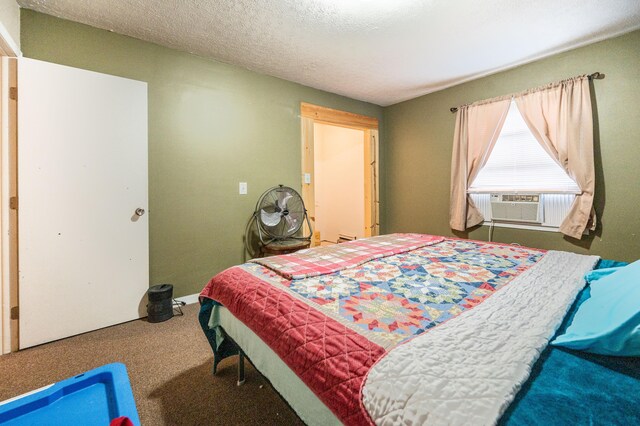 carpeted bedroom with cooling unit and a textured ceiling