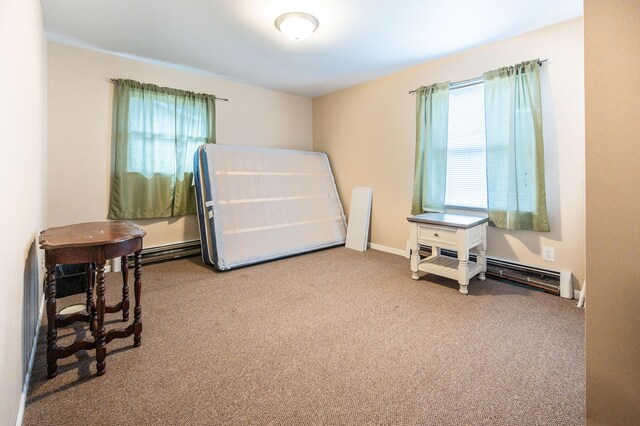 bedroom featuring baseboard heating and carpet floors