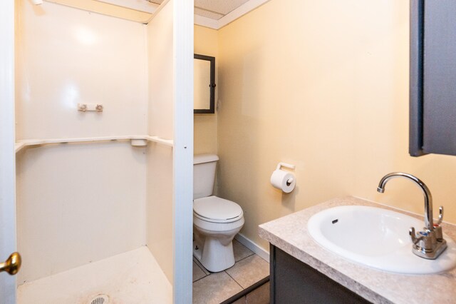 bathroom featuring tile patterned floors, vanity, and toilet