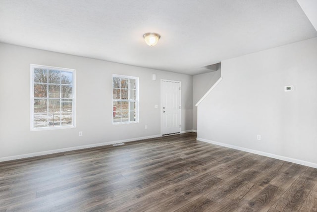 empty room with dark wood-type flooring