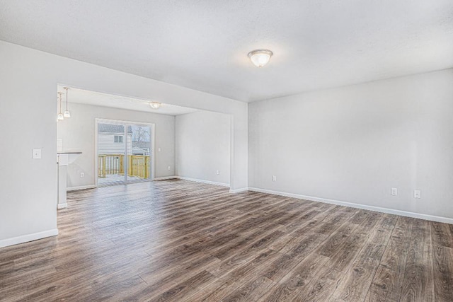 unfurnished room with dark hardwood / wood-style floors