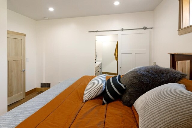 2144 N Jacobson Rd, Suttons Bay, MI 49682 - bedroom featuring baseboards, recessed lighting, and wood finished floors
