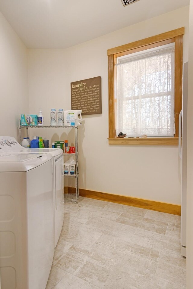 2144 N Jacobson Rd, Suttons Bay, MI 49682 - laundry area with baseboards and washer and clothes dryer