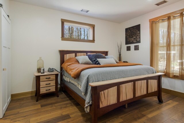 2144 N Jacobson Rd, Suttons Bay, MI 49682 - bedroom featuring baseboards and wood finished floors