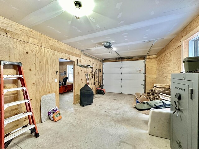 2144 N Jacobson Rd, Suttons Bay, MI 49682 - garage with a garage door opener and wooden walls