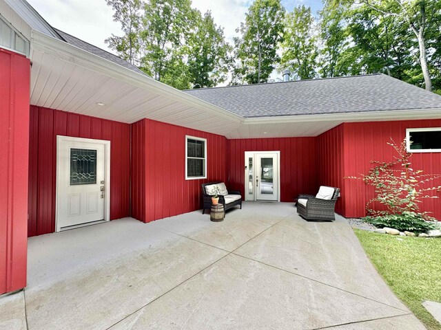 2144 N Jacobson Rd, Suttons Bay, MI 49682 - view of exterior entry featuring a patio area and roof with shingles