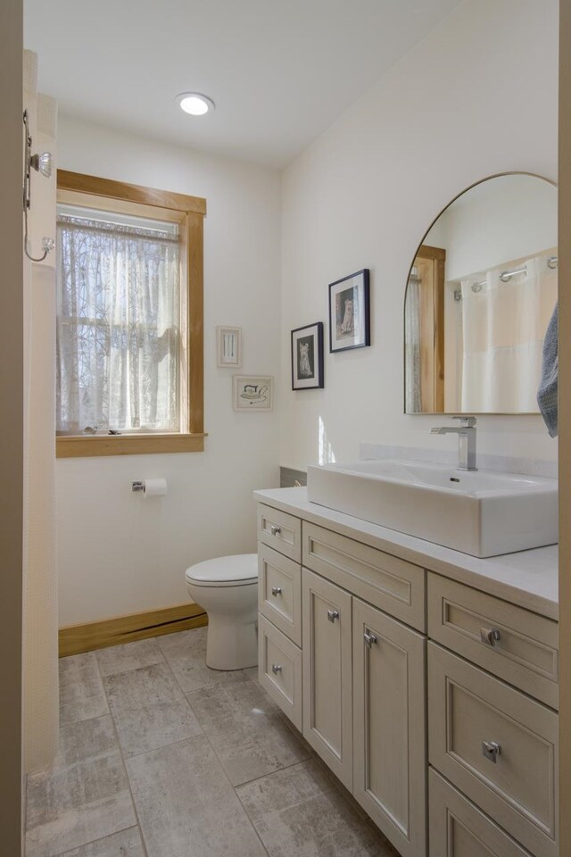 2144 N Jacobson Rd, Suttons Bay, MI 49682 - bathroom with vanity, toilet, and baseboards