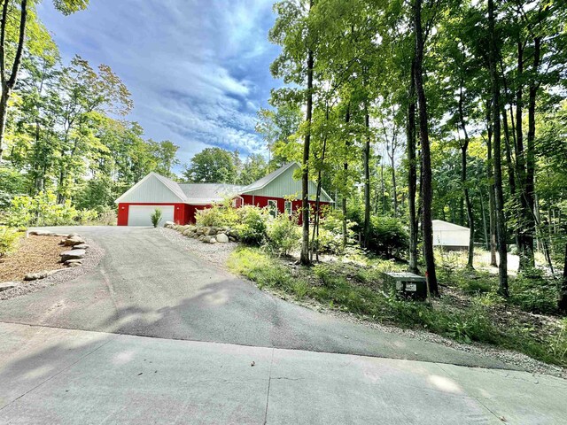2144 N Jacobson Rd, Suttons Bay, MI 49682 - view of front of house featuring driveway and an attached garage