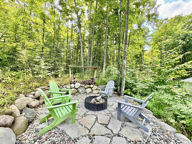 2144 N Jacobson Rd, Suttons Bay, MI 49682 - view of patio / terrace with an outdoor fire pit