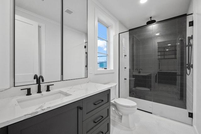 bathroom featuring tile patterned flooring, vanity, toilet, and a shower with door